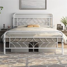 a white metal bed frame sitting on top of a carpeted floor next to a window