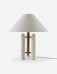 a lamp that is sitting on top of a white surface with two tubes attached to it