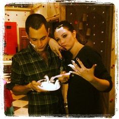 a man and woman eating food together in a kitchen with the caption gossip gritteam