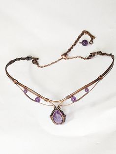 Enhance your look with this stunning 6ct Amethyst choker in copper! Handcrafted with quality materials, this choker features a beautiful Amethyst gemstone in the center, set in copper wire wrap that creates a beautiful and eye-catching design. The copper wire wrap is intricately detailed and flows gracefully around the gemstone, giving it an elegant feel. The choker fits comfortably around the neck and is lightweight enough to be worn all day. You'll be sure to make a bold statement with this un Wire Necklace Patterns, Luxury Wire Wrapped Jewelry Gift, Wire Necklace Designs, Wire Wrapped Clasps, Copper Wire Necklace, Wire Choker Necklace Diy, Fantasy Wire Jewelry, Wire Wrap Choker, Wire Wrapped Leaf Pendant