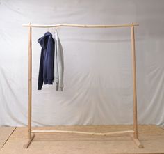 a clothes rack with two coats hanging on it