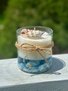 a glass jar filled with rocks and sea shells