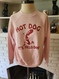 "Here is an awesome vintage sweatshirt by Tultex 50/50 polyester and cotton blend, and made in the USA. Light pink shirt with bold red graphic. About the design. This graphic was on a t-shirt from the 80s that I had for a while. I relished how goofily adorable it was. But to be frank, the shirt it was on was a child's small, which did me no good. I was able to catch up with my friend Jesse, and he worked his buns off to replicate the design for printing on adult sized shirts. This is the second Retro Crew Neck Pre-shrunk Top, 90s Style Crew Neck Sweatshirt With Screen Print, Vintage Long Sleeve Slogan Sweatshirt, Retro Crew Sweatshirt With Screen Print, Retro Crew Neck Sweatshirt With Screen Print, Retro Cotton Sweatshirt With Screen Print, 90s Crew Neck Sweatshirt With Screen Print, Vintage College Sweatshirt With Text Print, Vintage Sweatshirt With Text Print In Relaxed Fit