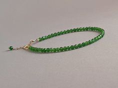 Such a delicious bracelet with vibrant green chome diopside rondelles  Please measure tightly your wrist's circumference, using a ribbon or something similar, and then measuring the ribbon with a ruler. When ordering, please select the actual wrist size, not the size of the bracelet. I will make the bracelet fit your wrist, by adding approx 0.6 inch to the circumference. The bracelet was set up using genuine chrome diopside faceted rondelles and sterling silver findings and it is adjustable. Diopside, also called ' The Analytical Stone' is an empowering stone that helps to stimulate learning and understanding, to help one become better connected to the earth, and to bring love to oneself as well as other. Said to hold all the mysteries of the Universe many find that the green Chrome Diopsi Green Chrome, Delicate Jewelry, Green Gemstones, Vibrant Green, Gemstone Healing, Delicate Bracelet, Arm Band, Ruler, Jewelry Gift