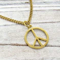 Gold Peace Sign Necklace, Peace Symbol Pendant, Peace Pendant Necklace, Hippie Necklace, Boho Necklace, Necklace for Men, Men's Necklace, Woman's Necklace, Peace Sign Jewelry, Peace Sign, Peace NECKLACE STYLE AND LENGTH: Please select the style and length of necklace from the drop down lists. Yellow Gold Tone Stainless Steel Chains: Flat Link 4 x 3 x .8mm, Twist Curb 4 x 3 .8mm and Ball Chain 2.4mm and includes a lobster clasp closure or ball connector for Ball Chain. Waxen Cotton Cord: Strong a Peace Sign Jewelry, Peace Jewelry, Peace Necklace, Peace Sign Necklace, Sign Necklace, Brown Jewelry, Hippie Necklace, Suede Cord, Necklace Necklace