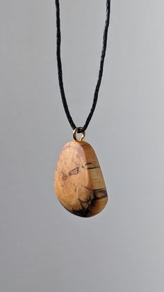 This is a handcrafted birch wood pendant made from locally recycled wood. This pendant features a beautiful and unique pattern caused by the natural decay of birch wood, as well as a hand sculpted design to complement it. The result is a timeless, breathtaking and organic piece of jewelry that suits women, men and children for almost any occasion or simply everyday life. I make these using only naturally fallen wood that I find on walks through my local forests - occasionally in the company of m Natural Carved Necklaces As Gift, Handmade Natural Wood Pendant Jewelry, Rustic Wooden Beads Necklace As Gift, Rustic Wooden Beads Necklace For Gift, Rustic Wooden Bead Necklaces For Gifts, Gift Wooden Bead Necklaces In Natural Wood, Natural Wood Necklaces With Wooden Beads For Gift, Handmade Wooden Necklace Gift, Nature-inspired Natural Wood Jewelry With Variations