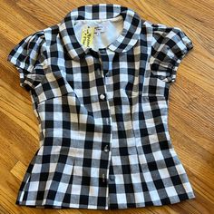 Women’s Black And White Buffalo Plaid Gingham Rockabilly Collared Blouse. Cute Round Buttons Down The Front. Elastic At Arms For Stretch. Purchased From Unique Vintage. New With Tags. Size Large. Approximately 15 Inches Laying Flat Across At Waist. Fitted Casual Plaid Blouse, Fitted Gingham Shirt With Short Sleeves, Fitted Plaid Cotton Tops, Cotton Short Sleeve Blouse For Picnic, Cotton Blouse With Short Sleeves For Picnic, Classic Gingham Cotton Blouse, Fitted Short Sleeve Tops In 1950s Style, Fitted Gingham Button-up Shirt, Fitted Gingham Casual Shirt