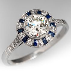 a diamond and blue sapphire ring with diamonds on the sides, set in white gold