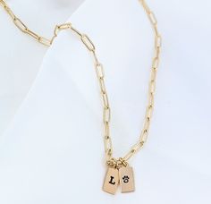 One of our best-sellers, a "can't go wrong" piece that can elevate any outfit whether worn alone or layered with others. Embodying personalization and elegance, this necklace is designed to last a lifetime and add a touch of luxury to any jewelry collection. The necklace is available in a variety of lengths (15", 16", 18", 20") so you can choose the perfect fit for you. Yet, if you need help in deciding on the length, you can take a look at the size chart in the photos or let us know in the chat Tiny Tags Necklace, Initial Tag Necklace, Tiny Tags, Jewelry Cleaner, Tag Necklace, Organza Bags, 14kt Gold, Paper Clip, Initial Necklace