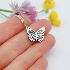 "Voici un pendentif monarque en argent sterling minuscule et détaillé. Ce charme est oxydé et poli pour créer du contraste et de la profondeur. Suspendu en diagonale sur une chaîne de 18 pouces. 1/2\"de haut X presque 3/4 » de large. Illustré dans une finition polie mais peut être brossé si vous préférez." Elegant Silver Jewelry With Butterfly Print, Butterfly Shaped Sterling Silver Jewelry Gift, Butterfly Shaped Sterling Silver Jewelry For Gifts, Silver Butterfly Necklace With Butterfly Clasp, Sterling Silver Butterfly Jewelry Gift, Sterling Silver Jewelry With Butterfly Clasp, Silver Sterling Silver Jewelry With Butterfly Clasp, White Gold Necklace With Butterfly Charm In Sterling Silver, White Gold Necklace With Butterfly Charm