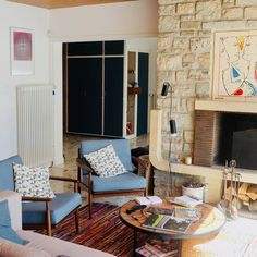 a living room filled with furniture and a fire place