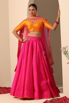 Hot pink solid lehenga crafted in tafetta silk with statement tassels. Paired with a blouse and gota lace bordered dupatta.
Components: 3
Pattern: Embroidered
Type Of Work: Gota lace
Neckline: V Neck
Sleeve Type: Elbow
Fabric: Lehenga and Blouse: Tafetta Silk, Dupatta: Soft Net
Color: Pink
Other Details: 
Length:
Lehenga: 40 inches
Dupatta: 2.5 mtrs
Dupatta width: 44 inches
Occasion: Mehendi and Haldi - Aza Fashions Lace Lehenga, Lehenga And Blouse, Haldi Outfits, Pink Lehenga, Lehenga Blouse, Lace Neckline, Indian Outfit, Indian Wedding Dress, Desi Fashion