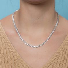 The Diamond Tennis Necklace is a piece of jewelry that features multiple diamonds set in a line or pattern, attached to a necklace. This specific necklace has a total carat weight of 20.00 carats. The diamonds are set in a 3-prong setting, which is a popular choice for displaying the diamonds in a way that minimizes the amount of metal around the diamonds, giving them a more open and airy appearance. The diamonds are 4.00 mm in size and the necklace is made of 14K gold, which is a popular type o Luxury Tennis Necklace With Vvs Clarity As A Gift, Luxury Diamond Cut Sterling Silver Tennis Necklace, Luxury Women's Tennis Necklace With Single Cut Diamonds, Luxury Fine Jewelry Cubic Zirconia Tennis Necklace, Luxury White Tennis Necklace For Formal Occasions, Luxury Iced Out Classic Tennis Necklace, Luxury Sterling Silver Diamond Cut Tennis Necklace, Luxury Tennis Necklace With Single Cut Diamonds For Women, Luxury Diamond Tennis Necklace With Box Chain