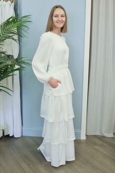 Come check out this new beautiful dress that we just got in. It is a soft stretchy fabric that flows and looks so elegant. This temple dress has pockets as well. Elegant V-neck Dress With Flowy Skirt, Dressy V-neck Dresses With Ruffles, Fitted Bridesmaid Midi Dress With Ruffle Hem, Fitted Maxi Dress With Ruffle Hem, White Flowy Bridesmaid Dress, Bridesmaid Dresses With Ruffles And Tiered Skirt, Fitted Tiered Dress For Casual Wear, Fitted Tiered Dress For Dress Down Occasions, Fitted Dressy Dresses With Ruffle Hem