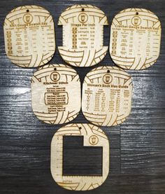 four wooden coasters with numbers on them sitting on top of a wood table in front of a black wall