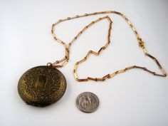 "Welcome to my Instagram account @Jewelrin Vintage/ Antique Old Metal Brass Unmarked Floral Locket Necklace Pendant. I believe this item to be made of brass but I could be mistaken. The locket shows overall wear including scratches and discoloration; the clasp still works well. The chain is made of goldtone metal. Measurements/size: The chain measures 27\" (68 cm). The locket measures 2\" (5 cm ) in diameter. Marks or signatures: Unsigned Condition - Very good vintage condition. Take a look at m Antique Gold Metal Locket Necklace, Ornate Gold Locket Necklace In Brass, Antique Gold Medallion Locket Necklace, Ornate Gold Brass Locket Necklace, Antique Gold Locket Necklace Nickel-free, Gold Brass Locket Necklace For Formal Occasions, Gold Brass Locket Necklace For Formal Events, Antique Gold Nickel-free Locket Necklace, Ornate Bronze Locket Necklace In Brass