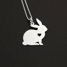 "Sterling Silver Bunny necklace Rabbit necklace ♣NOTE: All Pendant has a Heart- and Engraving is not Related to the heart - the heart is cutout ♣NOTE: if you don`t want a heart please mention it on your order Item Description : ♣ Material: Sterling Silver ♣ Thickens of Pendant : 22 Gauge (0.64 mm) ♣ Finish: Bright Satin Finish ♣ Size of the pendant : around 3/4 \" ♣ Chain Material: Sterling Silver Box Chain (Made in Italy) ♣ 16\"-18\"-20\" Chains Thickness is 0.8 mm ♣ 22\" inch Chain Thickness i Cute Silver Heart Pendant Jewelry, Silver Necklace With Heart Charm For Birthday, Silver Heart Charm Necklace For Birthday Gift, Sterling Silver Heart Pendant Necklace For Birthday, Sterling Silver Heart Pendant Necklace As Birthday Gift, Valentine's Day Silver Charm Necklaces, Cute Sterling Silver Necklace Gift, Cute Sterling Silver Necklace For Gift, Valentine's Day Silver Necklaces With Charms