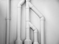 black and white photograph of pipes in a room