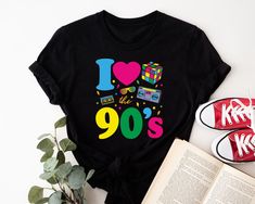 This t-shirt is the perfect choice for anyone attending an 90s-themed party or event. The shirt features a crew neck and short sleeves, making it a comfortable option for any occasion. The graphic tee design showcases the phrase "This Is My 90s Costume" in a fun and festive font. Made from soft and durable cotton jersey fabric, this regular fit t-shirt is machine washable for easy care. Whether you're dressing up for a wedding, party, or simply casual wear, this t-shirt will be a hit. So channel your inner 90s vibe and make a statement with this must-have piece. Size Chart is given in the listing pictures! Washing Care  Wash your garment inside out at low temperature (30 degrees) and always wash with cold water. Do not tumble dry or iron on the print.  Service We take pride in our work and Cheap 90s Inspired Graphic T-shirt, Cheap 90s Style T-shirt With Sublimation Print, Cheap Multicolor 90s Style T-shirt, 90s Style Stretch T-shirt, Cheap 90s Inspired Screen Print T-shirt, Affordable 90s Inspired Screen Print T-shirt, Affordable 90s Style Shirt With Text Print, Cheap 90s Style Tops For Birthdays, Cheap 90s Style T-shirt For Fan Conventions