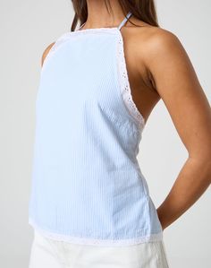 This blouse features a high neck halter design with a detailed tie back for an adjustable fit to your tailored desire. Elegant Spring Halter Top With Tie Back, Halter Neck Top For Summer Workwear, Chic Sleeveless Halter Top For Spring, Elegant Halter Neck Top With Tie Back, Elegant Backless Top With Tie Back, Elegant Backless Tank Top For Spring, Chic Backless Blouse For Spring, Chic Backless Spring Blouse, Elegant Backless Tie Back Top