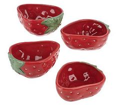 four red ceramic bowls with green leaves and dots on them, set against a white background