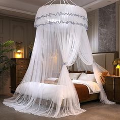 a canopy bed with sheer curtains in a bedroom