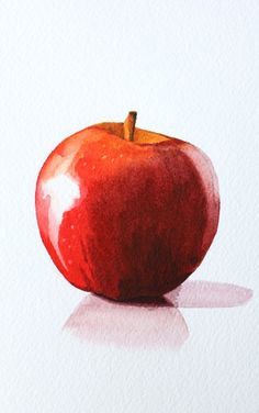 an apple sitting on top of a white surface