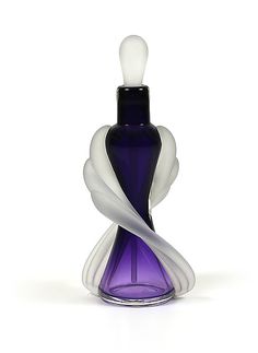 a purple and white bottle sitting on top of a table