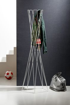 a coat rack sitting next to a soccer ball