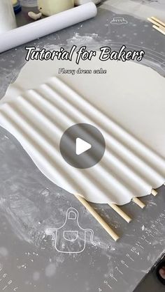 the video is showing how to make paper plates with wood sticks and glue on them