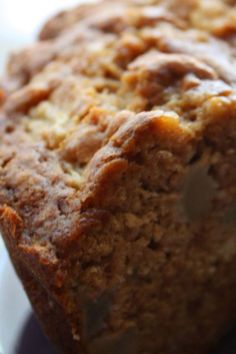 a loaf of banana bread sitting on top of a white plate