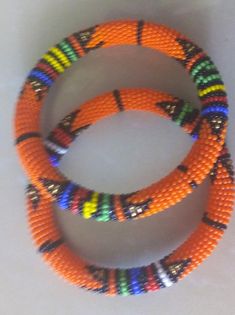 Beaded Bracelets | African Maasai Beaded Bracelets | African Jewelry | Zulu Beaded Bracelets | Ethnic Bracelets | Gift For Her | A Set Of Two These superbly crafted Zulu beaded bracelets are made of fine beads.The price is for a set of two bracelets.Main Color - Orange.Standard measurement is 7 - 8 inches.For smaller or bigger size please contact me.Available in different colors.Feel free to send me a convo or e-mail for any clarification.Thank you for visiting... African Beads Bracelets Handmade, African Beads Bracelets, African Bead Bracelet, Wrist Beads African, African Trade Bead Bracelet, African Beaded Bracelets, Wholesale Necklaces, Dainty Choker, Beautiful Beadwork