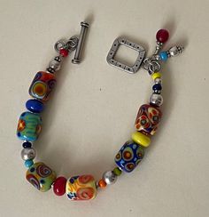 Multicolor Lampwork beads bracelet, handmade   excellent condition  7 1/2" with clasp x 7/16" w. Domestic shipping: USPS First class mail. 1-5 business days. I can file an insurance claim only after 20 business days after item was shipped International shipping: USPS First class mail. Approximately 7-21 business days. I can file an insurance claim only after 40 business days after item was shipped. I can not refund your money until claim is completed. Thank you. 11/08/23 1734 Unique Multicolor Round Beads Bracelets, Artisan Multicolor Polished Beaded Bracelets, Multicolor Glass Beaded Bracelets, Multicolor Czech Glass Bracelet, Unique Multicolor Bracelets With Large Beads, Multicolor Polished Bead Bracelet, Unique Multicolor Glass Beads, Colorful Spacer Beads For Bracelets, Artisan Multicolor Beaded Bracelets With Round Beads