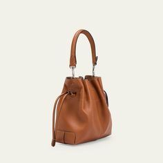 Tod's "Di" bucket bag in soft full grain leather  Detachable tubular top handle  Detachable, adjustable crossbody strap Can be worn as a top handle or crossbody bag  Drawstring closure  Distinctive Tod's logo stamped on the front Lining: Leather Approx. 6.6"H x 7.8"W x 3.9"D Made in Italy Leather Bucket Satchel For On-the-go, Modern Bucket Bag With Detachable Strap And Double Handle, Calf Leather Bucket Bag With Adjustable Strap, Brown Calf Leather Bucket Bag With Handle Drop, Luxury Cognac Bucket Bag With Adjustable Strap, Cognac Bucket Bag For On-the-go, Modern Cognac Bucket Bag With Removable Pouch, Modern Cognac Shoulder Bucket Bag, Classic Bucket Hobo Bag With Detachable Handle