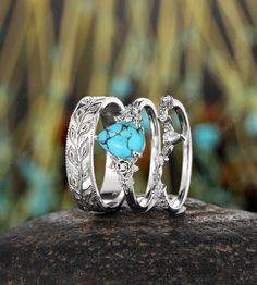 ITEM DESCRIPTION ✦Presenting our Couples Promise Ring set, a stunning representation of love and commitment.  The women's ring features a breathtaking 6x8mm pear-shaped natural mint blue turquoise as the main stone, beautifully complemented by shimmering moissanite side stones. The design is encased in a whimsical twig leaf floral setting, adding an organic and enchanting touch. For the men's band, enjoy a full eternity design featuring a twig leaf pattern, enhanced with intricate milgrain detai Silver And Turquoise Engagement Ring, Bohemian Stackable Wedding Jewelry, Stackable Turquoise Round Jewelry, Turquoise Sterling Silver Jewelry For Promise, Promise Ring In Turquoise Sterling Silver, Bohemian Round Jewelry For Wedding, Heirloom Turquoise Round Jewelry, Bohemian Round Promise Jewelry, Three-stone Aquamarine Jewelry For Gift