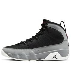 The Air Jordan 9 Particle Grey is a retro sneaker with a modern twist. This updated version of the '90s classic features a breathable black textile upper, speed laces, and tonal stitch detailing. The nubuck mudguard in a neutral grey finish wraps around the heel and extends up the mid-cut collar. Contrasting hits of crimson land on the sneaker's branding elements, including an Air Jordan tongue tag and a molded Jumpman emblem at the heel. Whether you're hitting the court or just hitting the streets, this sneaker is sure to turn heads. (AJ9/SNKR/Basketball) Sporty Jordan Lace-up Shoes For Streetwear, Sporty Lace-up Jordan Shoes For Streetwear, Sporty Jordan Shoes With Abzorb Midsole For Streetwear, Custom Black Mesh Sneakers With Branded Insole, Streetwear Mesh Basketball Shoes With Laces, Streetwear High-top Mesh Sneakers With Branded Insole, Black Nylon Sneakers For Jogging, Sporty Jordan Mid-top Shoes With Laces, Sporty Mid-top Jordan Shoes With Laces