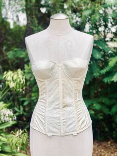 Pretty Vintage White Scalloped Corset from the 1950's. There is a lace pattern on the scalloped design of the bustier corset. Such a pretty top for an intimate addition to your outfit. Fitted Delicate Lace Corset, Elegant Underwire Corset With Lace Trim, Delicate Lace Fitted Corset, Delicate Lace Fitted Bodice Corset, Sweetheart Neckline Lace Corset With Delicate Details, Sweetheart Neckline Lace Corset, Feminine Delicate Lace Fitted Corset, Fitted Lace Corset Dress In Coquette Style, Lace Corset With Sweetheart Neckline And Lace Bodice