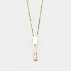 18k gold necklace with vertical gold bar and decorated with 3 diamonds in an elegant line prong setting. Handcraft spring ring clasp closer Necklace measure: 16 inches Pendant measure: 2.5 mm W x 30 mm H Minimalist Diamond Accents Bar Necklace As Gift, Minimalist Diamond Accents Bar Necklace Gift, Minimalist Bar Necklace With Diamond Accents For Gift, Minimalist Bar Necklace With Diamond Accents As Gift, Minimalist Bar Necklace With Diamond Accents, Modern 14k Yellow Gold Bar Necklace, Elegant Silver Rectangular Bar Necklace, Gold Minimalist Diamond Bar Necklace, Minimalist Gold Diamond Bar Necklace