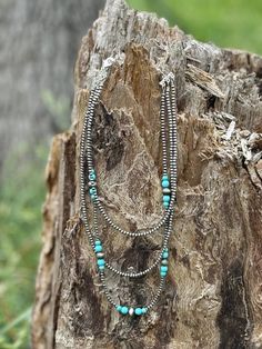 Make a statement with our Triple Layer Turquoise Bead Necklace! This necklace features three layers of vibrant turquoise and silver beads, adding a pop of color and a touch of Southwestern flair to any outfit. The layered design adds depth and dimension, creating a bold and eye-catching look. Faux silver and turquoise Cheap Blue Turquoise Southwestern Necklace, Turquoise Bohemian Beaded Necklaces For Layering, Turquoise Bohemian Beaded Necklace For Layering, Turquoise Bohemian Beaded Layered Necklace, Bohemian Turquoise Beaded Layered Necklace, Turquoise Beaded Multi-strand Layered Necklace, Turquoise Beaded Multi-strand Necklace, Silver Bohemian Beaded Necklaces For Layering, Bohemian Silver Turquoise Necklace With Spacer Beads