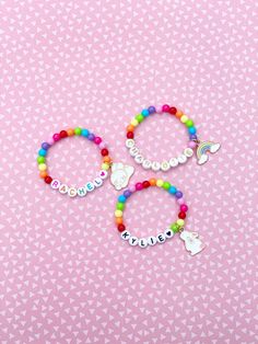 Adorable kids beaded bracelet with 6mm bright rainbow beads with your choice of name/lettering and charm. So cute and the charm adds such a unique look to your little one's bracelet! You can also choose not add a charm and just a name/word. Makes a great gift as well- everyone loves something personalized! Please provide the following information in the personalization field: -Name/word you would like -Heart color (if any)- red, orange, yellow, green, blue, purple, pink, black or gold -SIZING ** Novelty Personalized Charm Bracelet For Birthday, Birthday Beaded Name Bracelets With Round Beads, Personalized Novelty Charm Bracelet For Birthday, Birthday Beaded Bracelets With Name, Birthday Beaded Bracelet With Name, Personalized Multicolor Charm Bracelet For Birthday, Multicolor Personalized Novelty Charm Bracelet, Multicolor Name Bracelet With Letter Beads And Round Beads, Multicolor Name Bracelet With Letter Beads