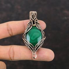 Note : Due to the natural formation of this gemstone. Slight variation in design and color are to be expected. Malachite Gemstone Pendant Copper Wire Wrapped Pendant Malachite Jewelry Gift For Mom Handmade Pendant Copper Wire Jewelry Stylish Pendants Handmade Copper Pendant SKU : VFWP-1186 Gemstone : Malachite Stone Shape : Oval     Metal Purity : Copper Pendant Length : 70 MM   Pendant Width : 33 MM There are many benefits associated with Malachite such as providing protection, alleviating negativity, and physically helping to enhance overall well-being like your immune system, your respiratory system, your liver, and your energy levels. Handmade Green Spiritual Gemstones, Artisan Malachite Gemstone Jewelry, Green Pendant Beads For Jewelry Making, Green Agate Beads For Jewelry Making, Handmade Green Gemstones For Jewelry Making, Green Wire Wrapped Agate Jewelry, Green Natural Stones For Jewelry Making, Green Agate Gemstone Beads, Green Gemstones With Stone Setting For Gifts