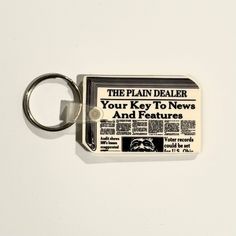 Discover the charm of nostalgia with our Vintage Ohio Plain Dealer Newspaper Keychain. This unique 80s rubber accessory is not just a key ring; it’s a piece of history that adds a delightful touch to your collection. Featuring a classic white color, this keychain is perfect for those who appreciate vintage collectibles and want to showcase their love for the past.Vintage Ohio Plain Dealer Keychain - Unique 80s Rubber Accessory Material: Durable rubber that stands the test of time Size: Compact 1 Vintage Keychain, Unique Keychain, Nostalgic Design, Holiday Puzzle, Character Making, Unique Keychains, Vintage Trucker Hats, Tie Shop, Travel Souvenirs