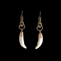 Real, bright white, 1 inch coyote canine teeth hang from 1 inch gold plated, Victorian style hands. Each are on gold filled French hook earrings. They drop to almost 3 inches. The coyote teeth are professionally cleaned and sterile. As with all of our natural animal products, these are harvested humanely from animals that are already deceased. None of our natural components are from animals that have been killed for the purpose of use in our jewelry, they are all by-products. This piece of jewelry is sent in a bubble pack envelope via US postal service, first class mail with insurance and comes in a gift box. International rate is $23. Buyers are responsible for any customs and import taxes that may apply. I am sorry, but Necromance is not responsible for delays due to customs, since when Animal Bone Jewelry Wire, Coyote Jewelry, Fang Jewelry, Canine Teeth, Tooth Earrings, Taxidermy Jewelry, Canine Tooth, Animal Teeth, Bone Earrings