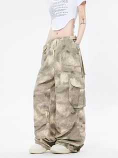 Embrace the street aesthetic with our Faded Baggy Camo Cargo Pants, perfect for making a statement while on the move.
Designed with a natural waist, these cargo pants offer a blend of comfort and durability. The camouflage pattern adds an edgy touch, while the drawstring and convenient pockets provide functionality and ease. The relaxed wide-leg silhouette ensures a nonchalant yet purposeful style, tailored for the contemporary wardrobe.
Pair them with a cropped hoodie and sneakers for running e Baggy Combat Parachute Pants With Wide Legs, Combat Style Baggy Wide Leg Parachute Pants, Y2k Cargo Style Khaki Bottoms, Baggy Wide Leg Y2k Cargo Pants, Y2k Khaki Cargo Bottoms, Y2k Style Khaki Cargo Bottoms, Baggy Y2k Pants With Multiple Pockets, Y2k Wide Leg Parachute Pants With Pockets, Y2k Baggy Pants With Multiple Pockets