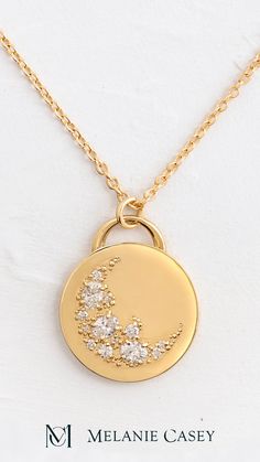 The Skyward Necklace was carefully handcrafted from solid 14k gold and depicts a crescent sweep made of ten round diamonds and three oval diamonds. ﻿The gold pendant is 19.5mm in diameter, 2mm thick and is available on its own or with a 20" rope chain that matches your choice of gold color: yellow, white, or rose. Find more images at melaniecasey.com. Elegant Crescent Engraved Necklace, Elegant Engraved Crescent Necklace, Celestial Style Jewelry With Round Cut Diamond Accents, Celestial Jewelry With Round Cut Diamond Accents, Fine Jewelry With Moon Charm For Wedding, Elegant Moon Charm Jewelry For Anniversary, 14k Gold Celestial Necklace With Single Cut Diamonds, Celestial Half Moon Jewelry For Anniversary, Elegant Gold Jewelry With Moon Phase Detail