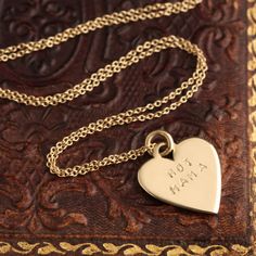 ((about)) I want to share a necklace I made for me AND for you: It's a tiny 14k gold blank heart we can stamp with a message, a name, a date - whatever you like. Use up to 12 characters, not including spaces. And once we stamp it, you own it—we don't allow exchanges or refunds on customized pieces like these. Indicate your message in the "notes" field at checkout. ((details)) Made by hand in our Brooklyn studio. Materials: 14k gold. Measurements: Chain measures 16". ((inspiration))In July, I had 14k Gold Heart Necklace With Hallmarks, Heart-shaped 14k Gold Name Necklace As Gift, 14k Gold Heart Name Necklace For Gift, Custom Engraved Heart Necklace For Gift, Hand Stamped Sterling Silver Necklaces In Yellow Gold, Everyday Heart Engraved Jewelry, Stamped 14k Gold Necklace For Anniversary, Everyday Gold Engraved Heart Necklace, Personalized 14k Stamped Name Necklace For Mother's Day