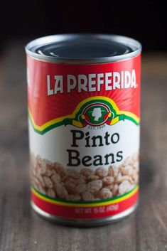 a can of pinto beans sitting on top of a wooden table