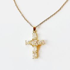 Introducing our Cross My Heart Necklace—a beautifully dainty piece that adds a touch of elegance to any outfit. Crafted in stunning gold, this timeless necklace features a delicate cross design adorned with a hint of sparkle, making it perfect for both everyday wear and special occasions. Lightweight and versatile, the Cross My Heart Necklace is designed for those who appreciate subtle sophistication. Whether you’re layering it with other pieces or wearing it solo, this necklace radiates a warm glow that complements your unique style. Celebrate your faith and express your individuality with this charming accessory. The Cross My Heart Necklace is not just a piece of jewelry; it’s a heartfelt statement that you’ll cherish for years to come. Perfect for gifting or as a special treat for yours Elegant Gold Plated Cross Pendant Necklace, Delicate Cross Pendant Necklace For Gift, Delicate Cross Necklace For Gift, Delicate Cross Necklace Perfect As A Gift, Elegant Cross Necklace With Delicate Chain, Delicate Cross Necklaces For Weddings, Dainty Gold Cross Necklace For Anniversary, Delicate Gold Cross Pendant Necklace, Delicate Cross Necklace For Wedding