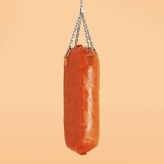 a red punching bag hanging from a chain