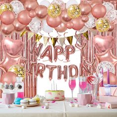 a birthday party with pink and gold balloons